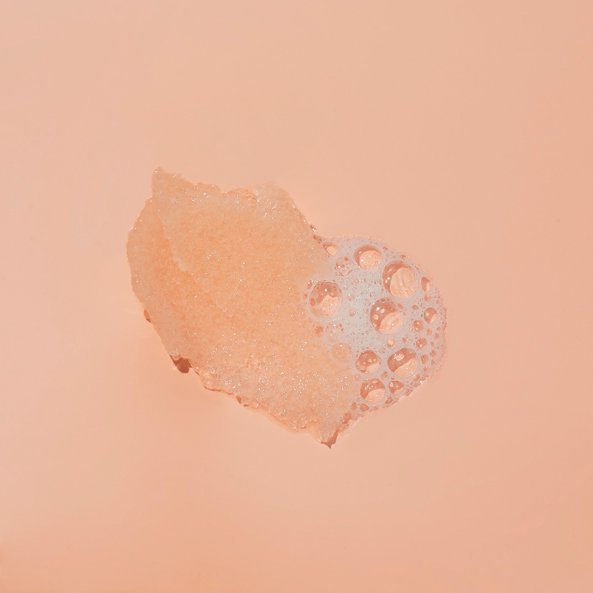 Sugar scrub texture with bubble on orange background